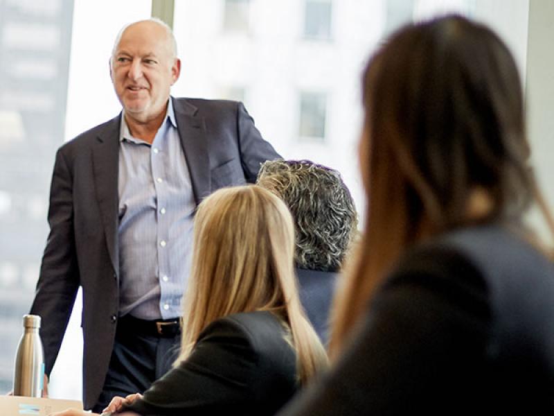 Bob Bodian speaking to colleagues in a conference room