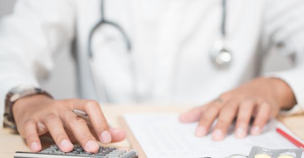 Doctor Using Calculator